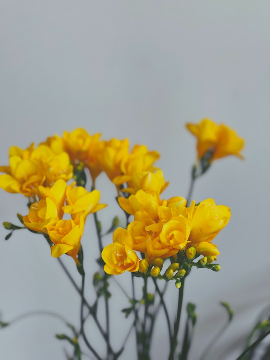 a vase filled with yellow flowers on top of a table